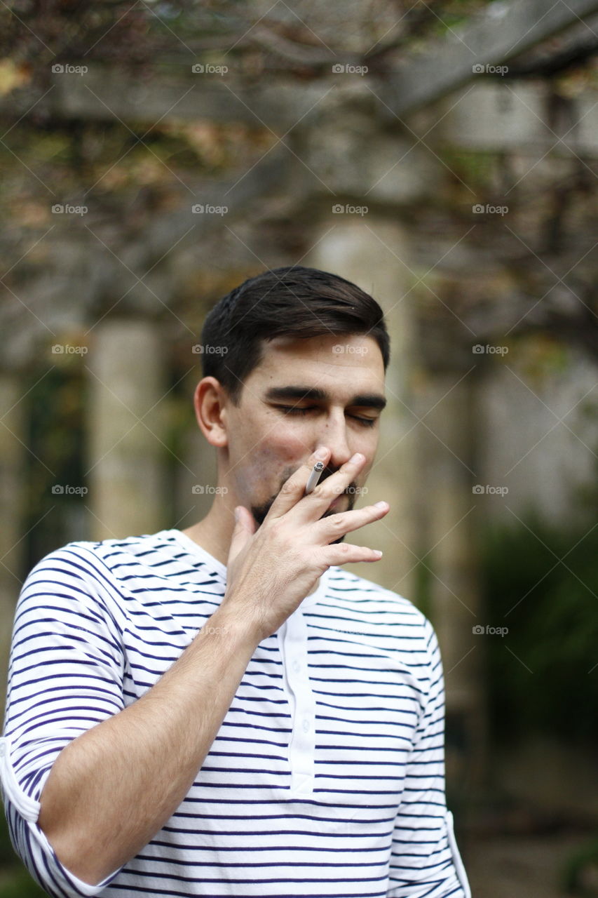 a man smoking his cigarette