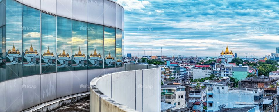 Miracle scene of famous gloden mount pagoda landmark in Bangkok reflect on glass of hotel