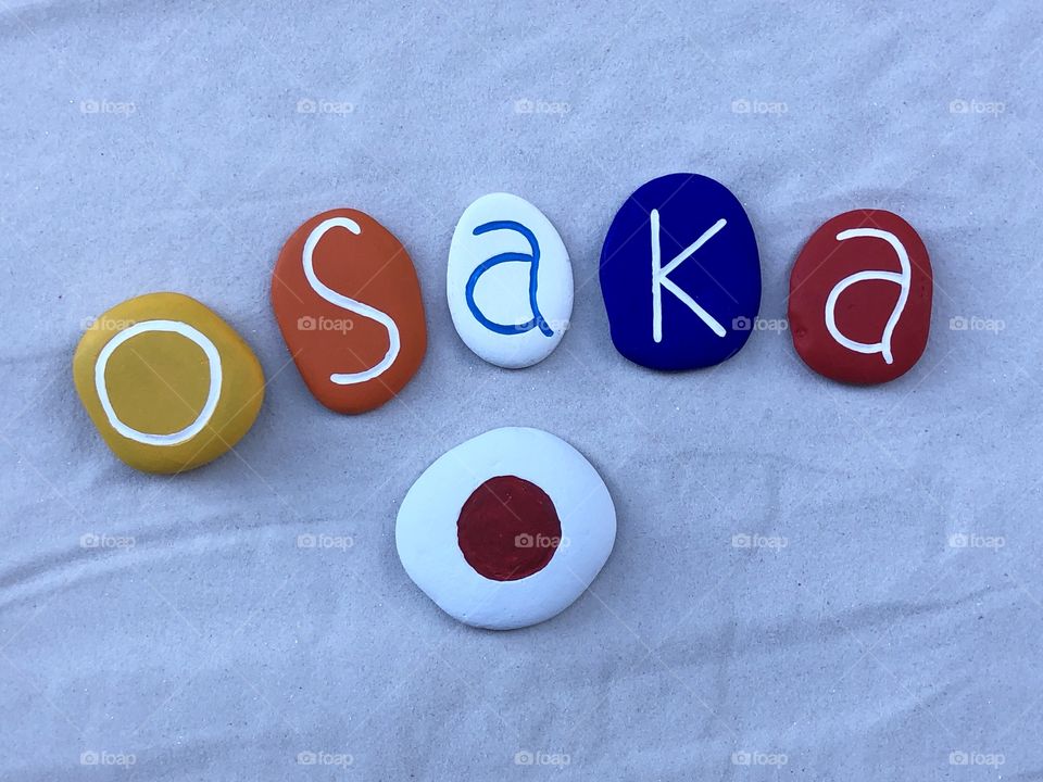 Osaka, Japan, souvenir of the japanese city with a composition of colored stones over white sand