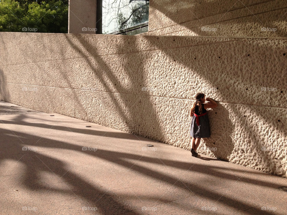 Little girl writing on wall