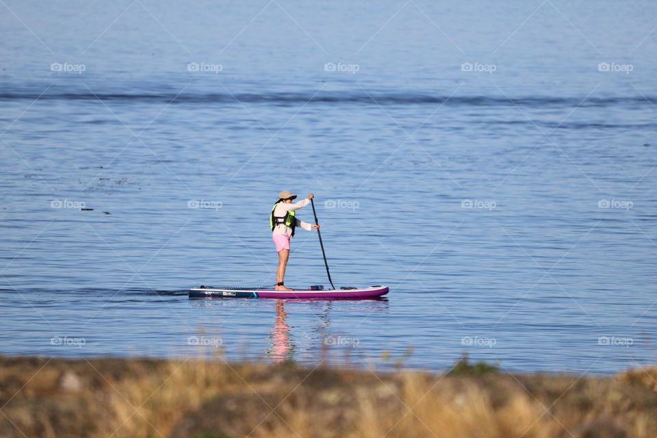 Woman paddling a punk board 