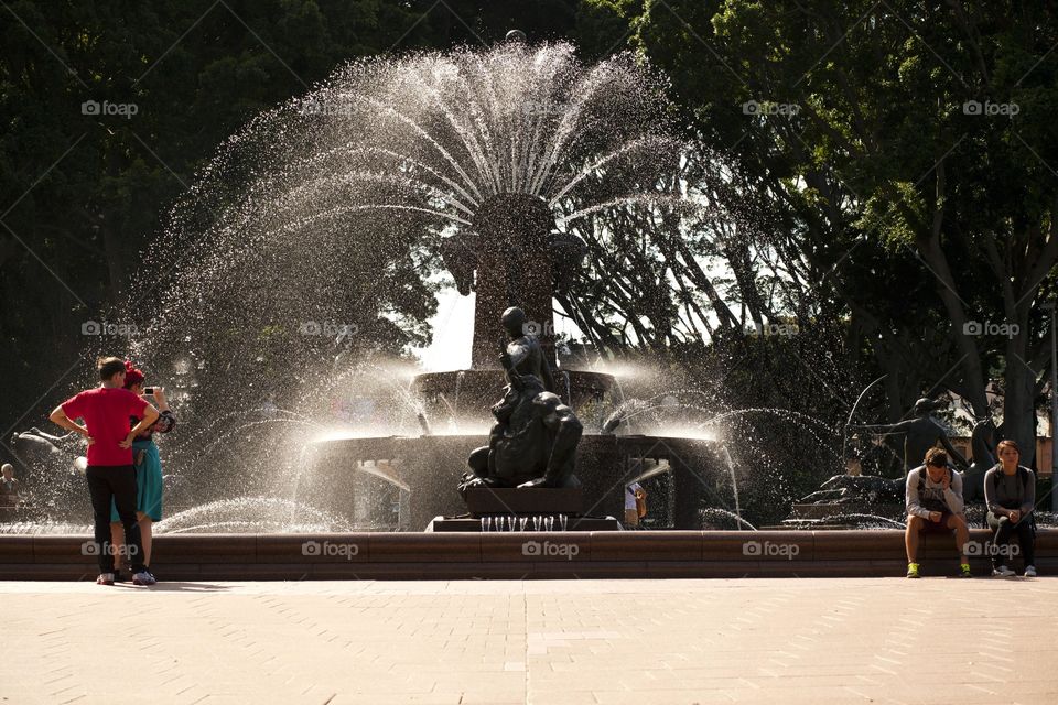 people chilling in front of Archibald fountain in Hyde Park, Sydney, NSW, Australia