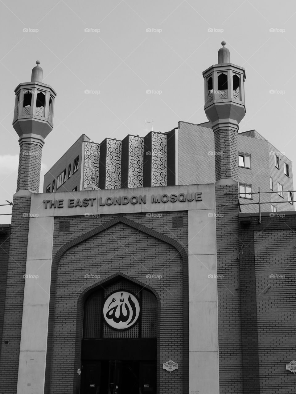 The beautiful architecture of the East London Mosque against a bright clear sky on a sunny summer day. 