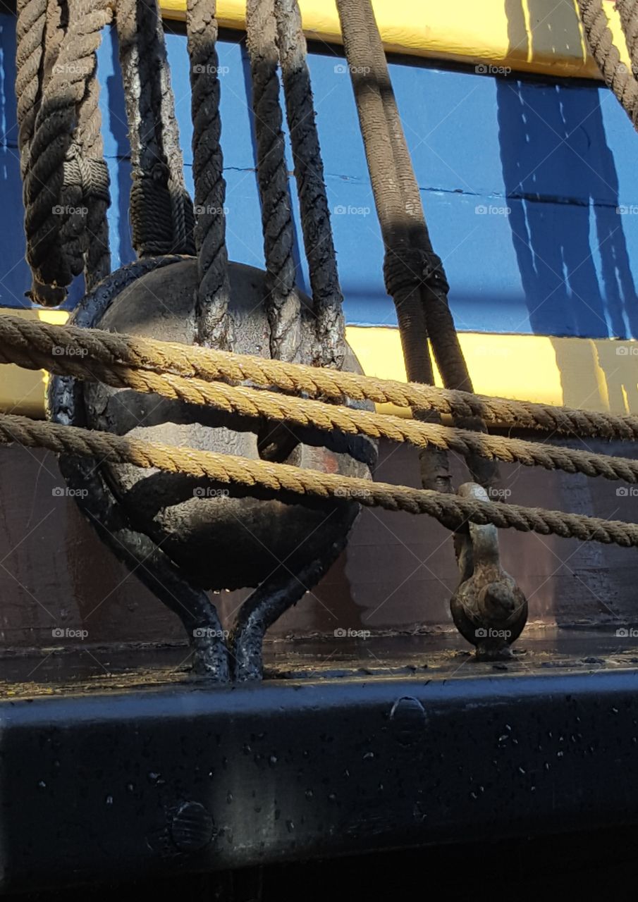 a close up view of a wooden block on the side of a sailing vessel that was docked in Monterey, CA