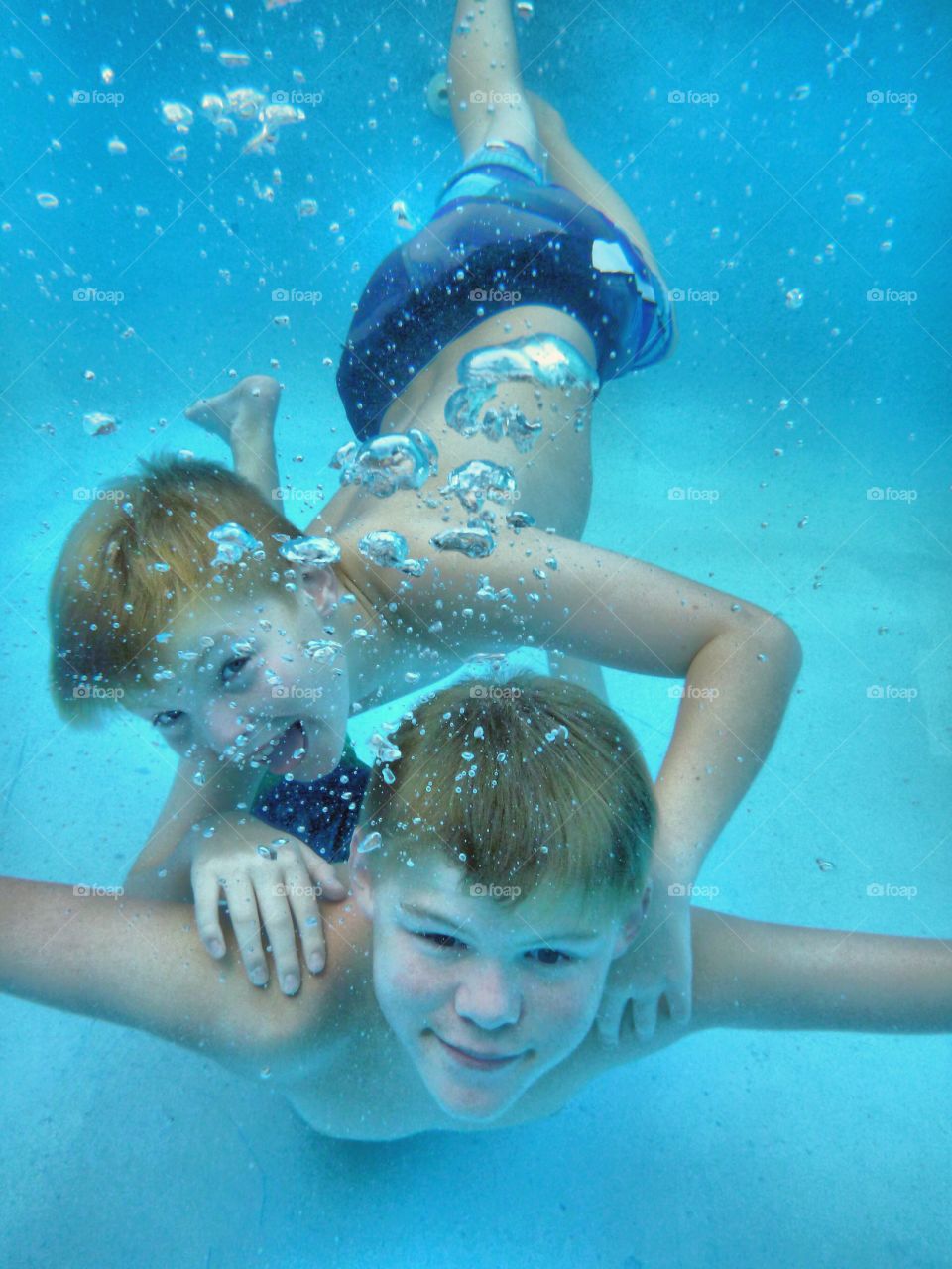 Sibling swimming in pool