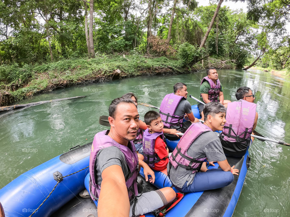 Tourists on the inflatable boat floating on the water in the river The flow of Kaeng Krachan Dam at Phetchaburi in Thailand. June 10, 2019