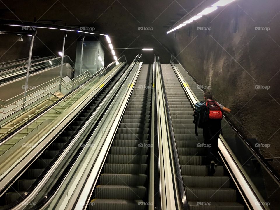 Man on escalator in metro station 