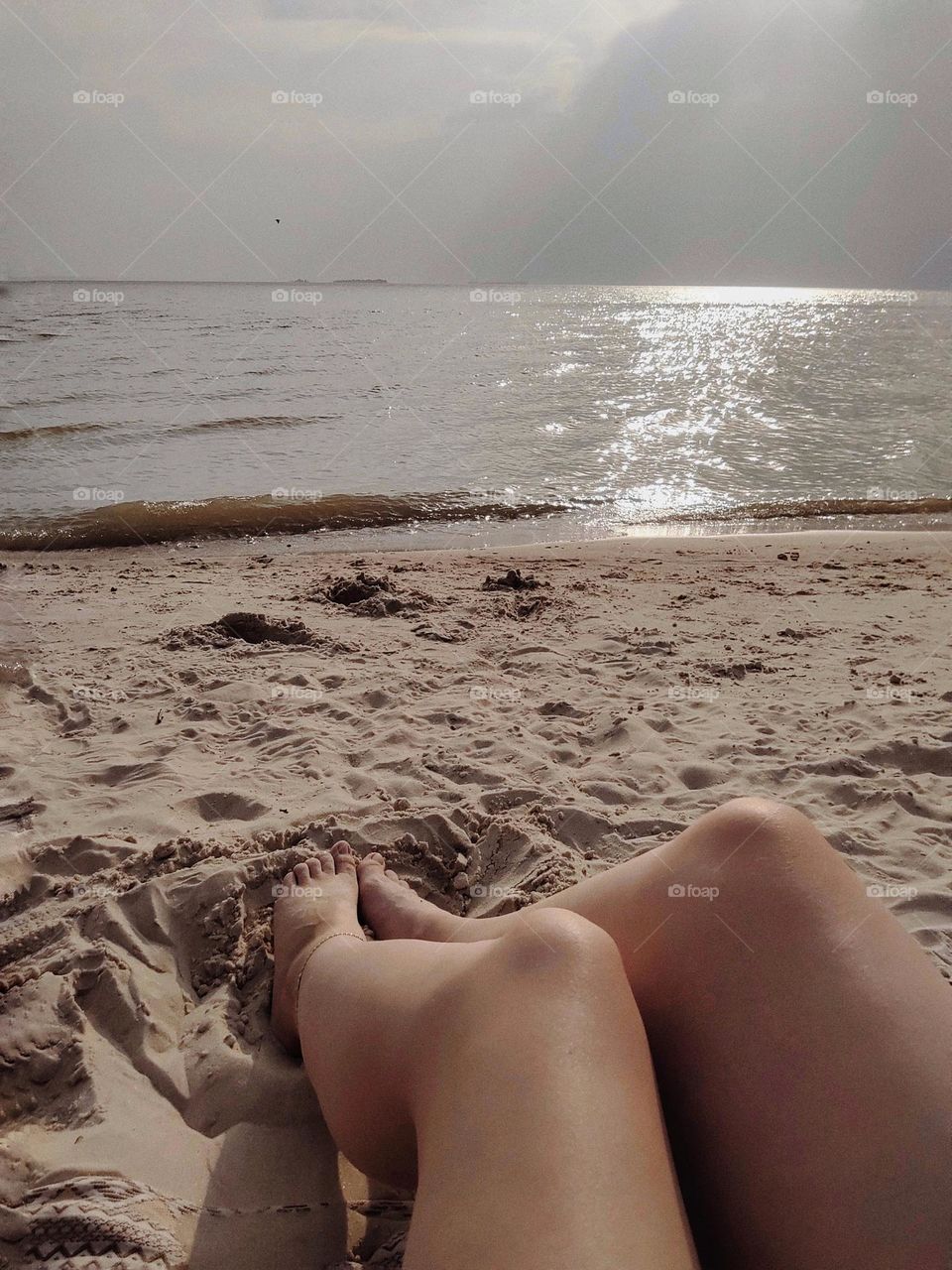 Women's legs on the seashore