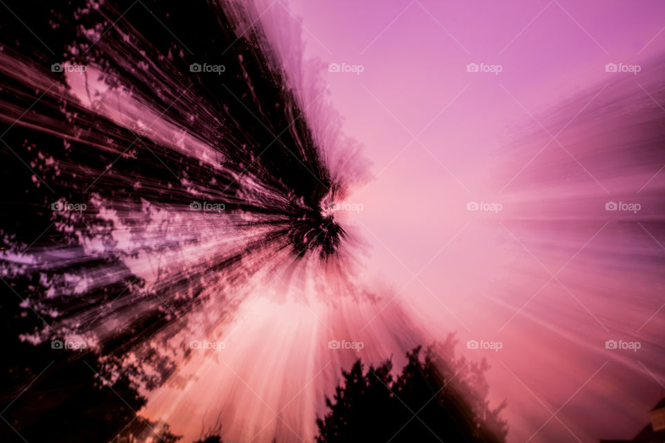 artistic sunset photograph with zoom blur trees