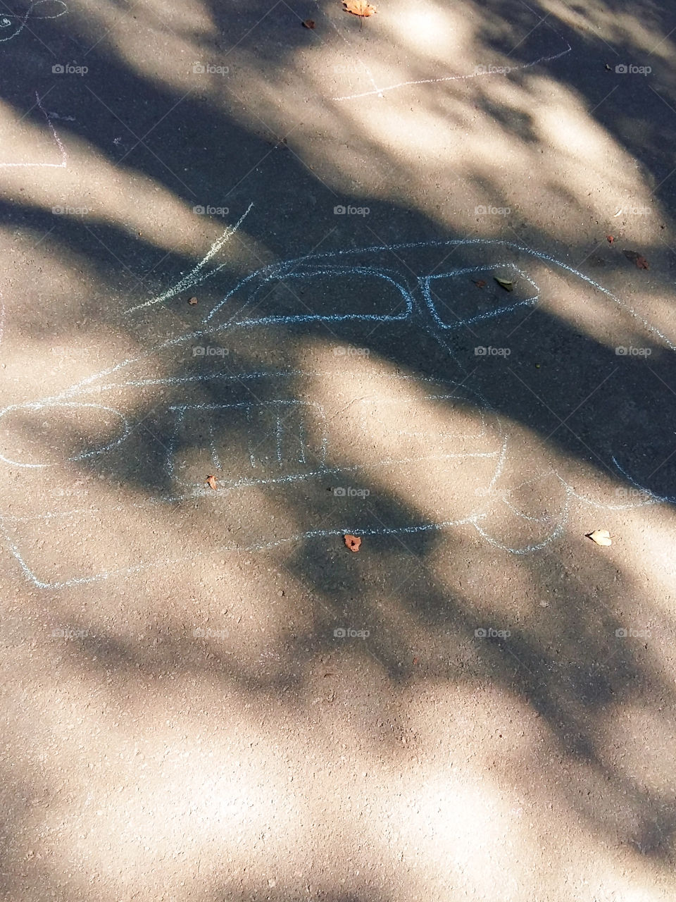 child drawing chalk machine on asphalt
