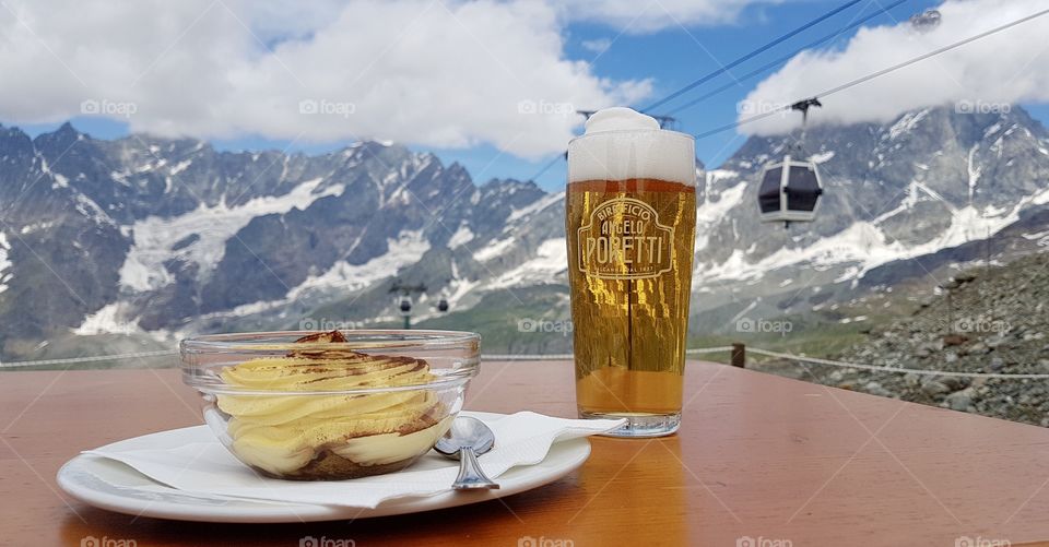 Collecting memories enjoying a dessert and beer in the Alps by the Matterhorn 
