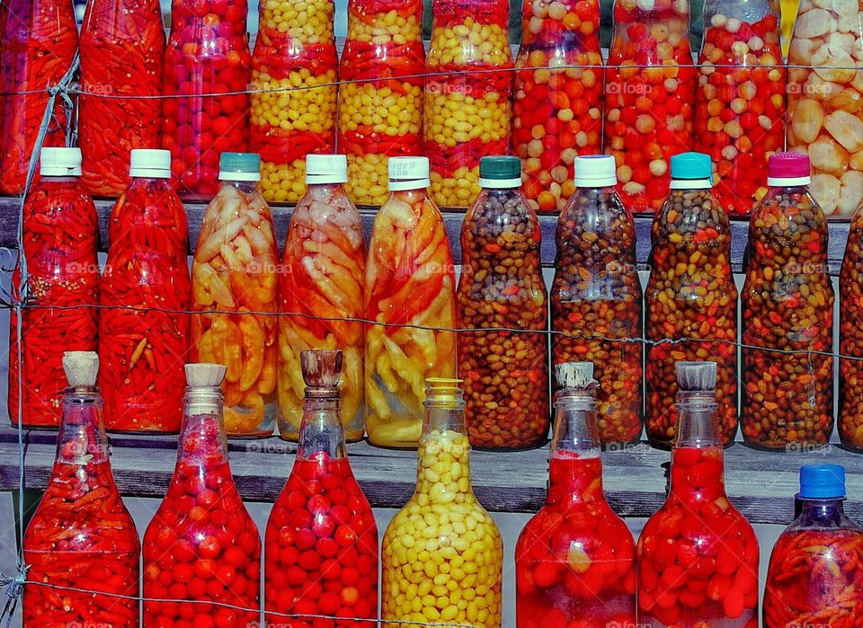 bottles with red peppers at a street sale