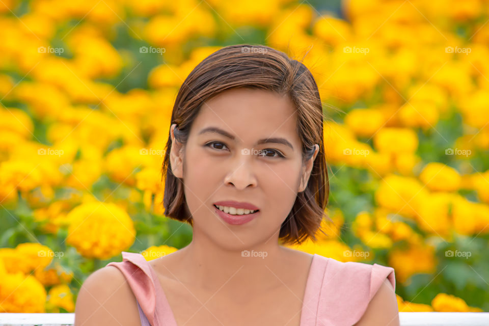 Woman in Yellow Marigold flowers garden or Tagetes erecta at Phu Rua, Loei in Thailand.