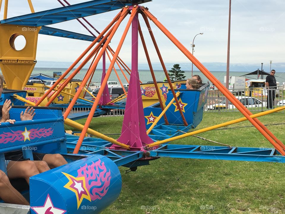 Amusement fair ride by ocean small town