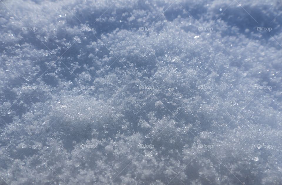 Macro shot of snow flakes and crystal looking snow