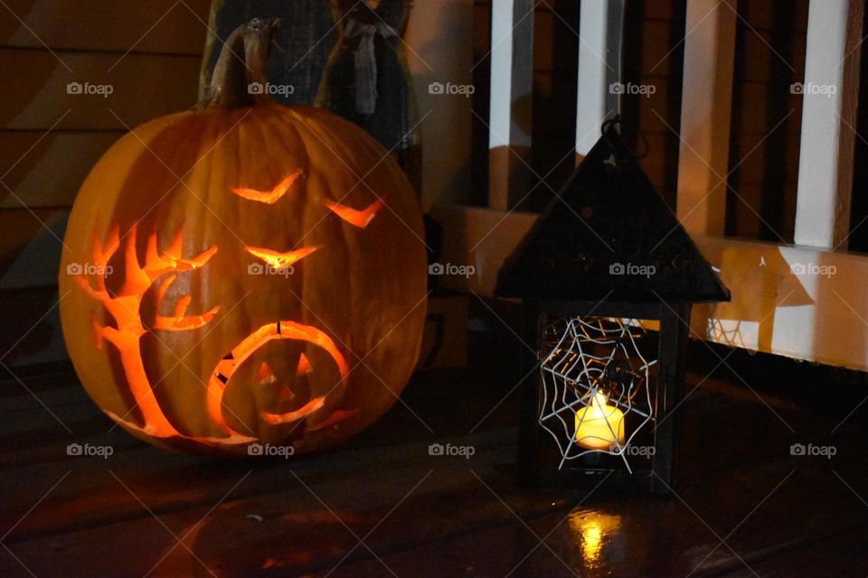 A jack-o’-lantern and a spooky lantern