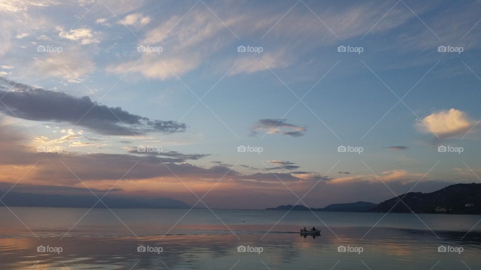 View of boat in lake during sunrise
