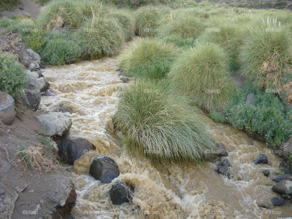 Brown Watter. Watter brings the minerals and soil from above the mountain,  leading to the main river
El Sosneado -Mendoza - Argentina