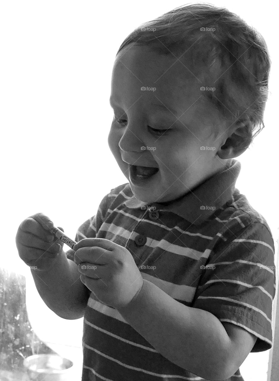 Happy Crayon! A toddler boy shows great excitement over his crayon. 