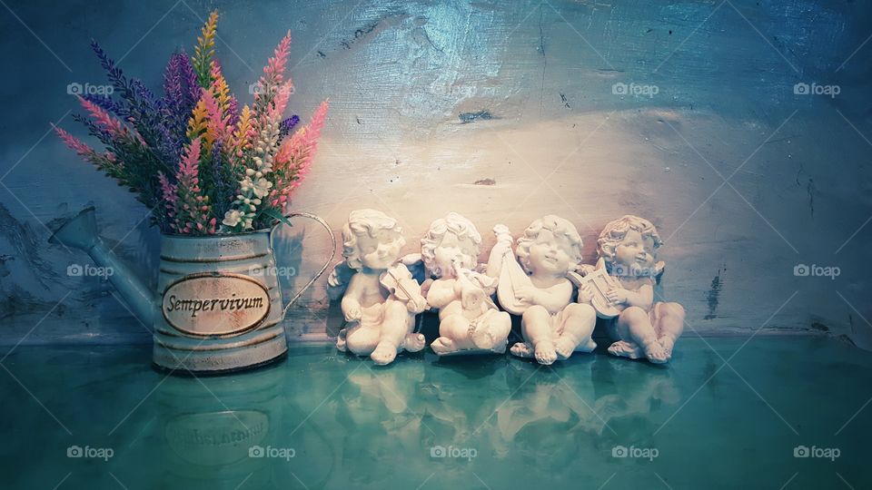 Vintage cute cement cupids and flower in teapot, beautiful background for valentines