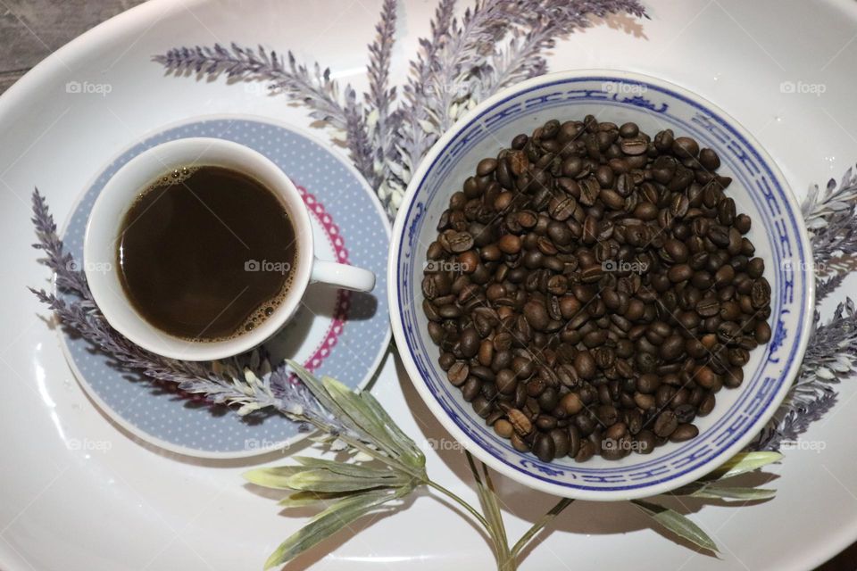 A cup of coffee and coffee beans