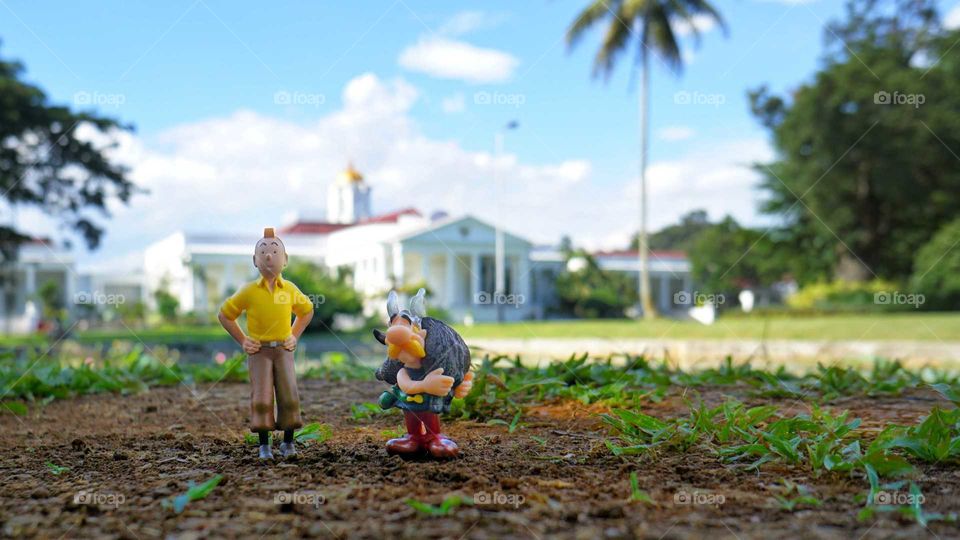 Tintin and Asterix figurines in front of Indonesia presidential palace of Bogor, near Jakarta, Indonesia