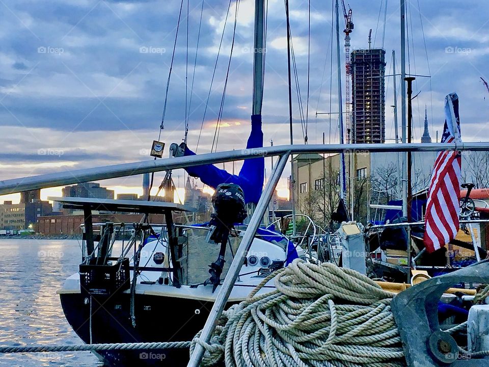 Rolls of rope, the silver colored railing, the neighboring sailboats as well as other boats, all this can be seen from aboard our boat “Salvation” on this partially overcast afternoon in December of 2021. Hypnotic Productions