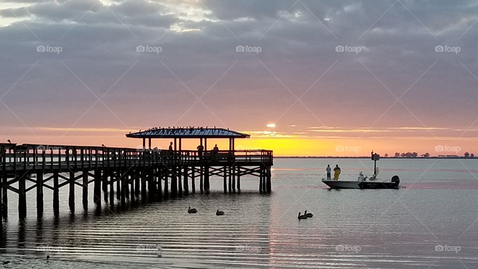 Safety Harbor pier at sunset with birds and boats