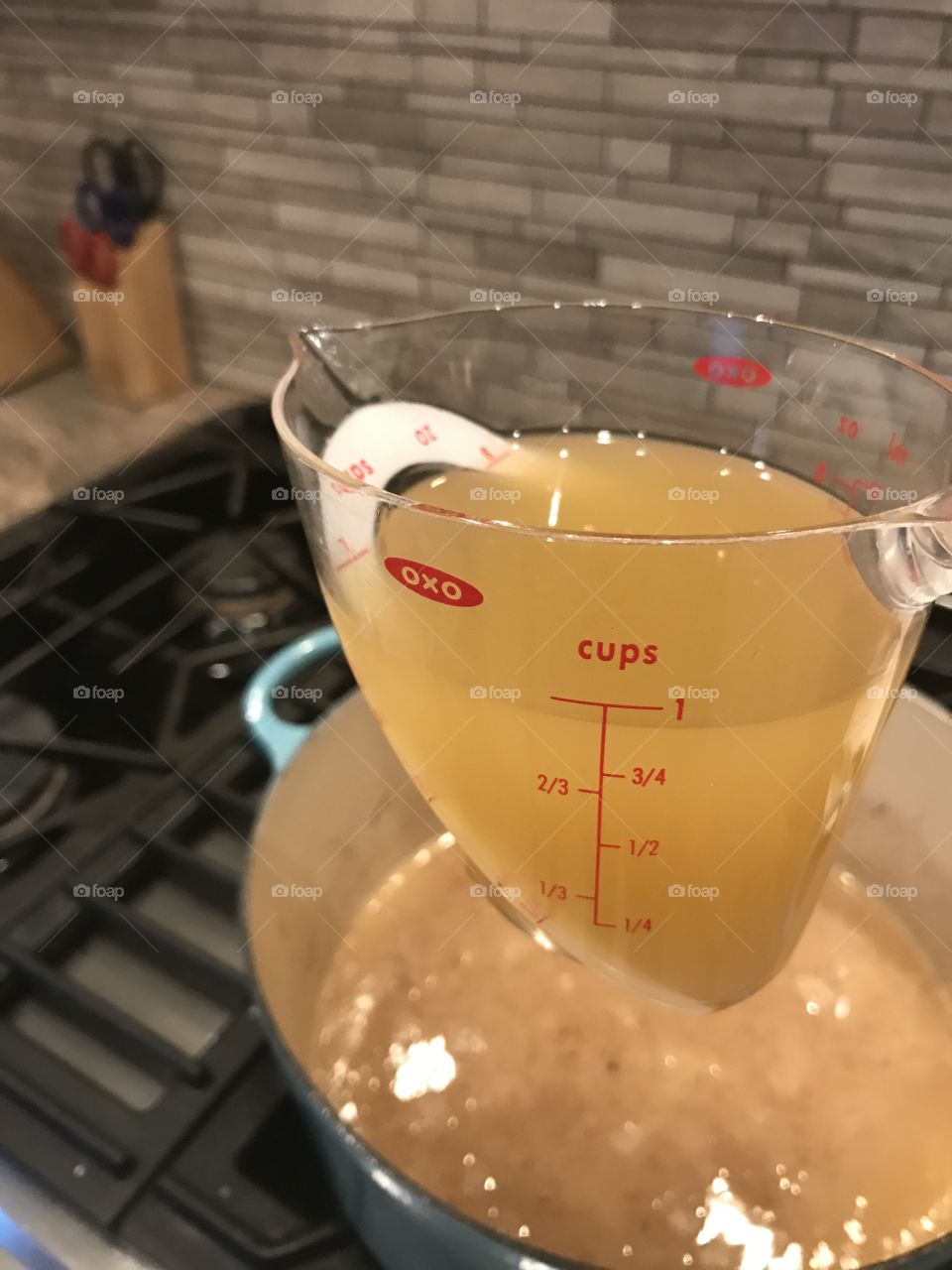 Measuring cup with broth