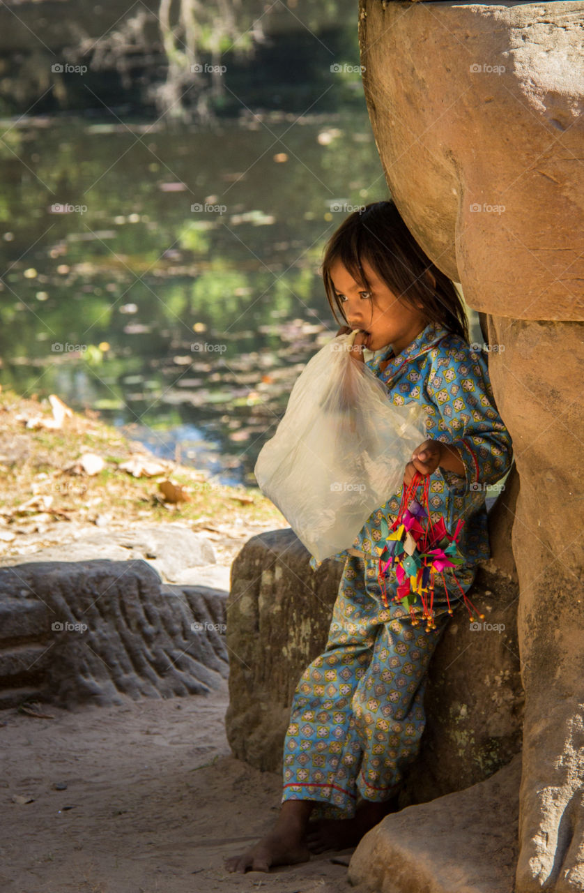 Souvenir seller hiding in the shade