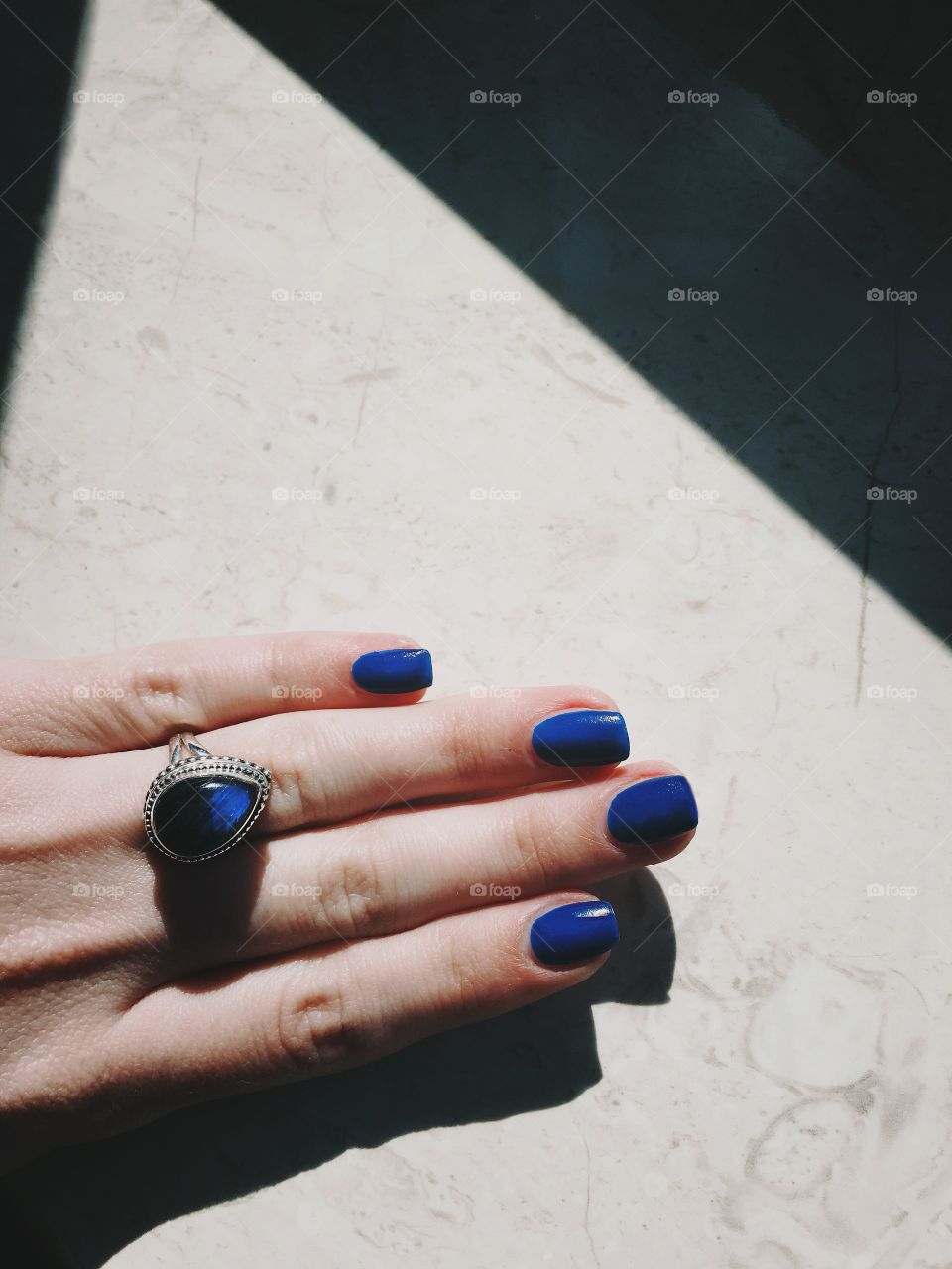 Blue nails and big silver ring with gemstone labradorite 