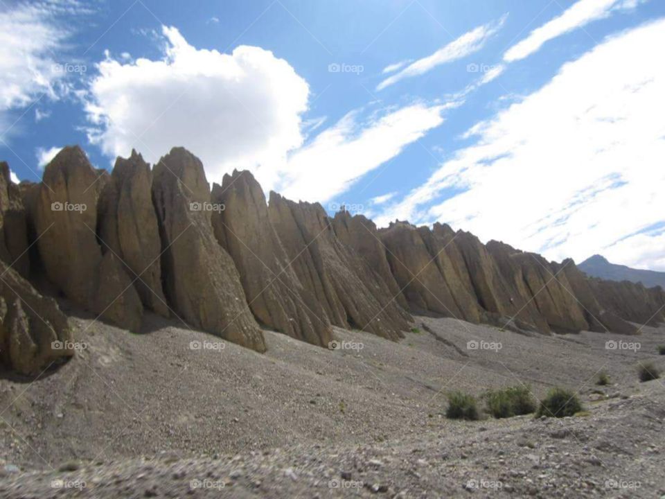 Lahaul Spiti, the beautiful place with the big stones, sky is covered with the white clouds, beautiful sun rays, small stones all the way....