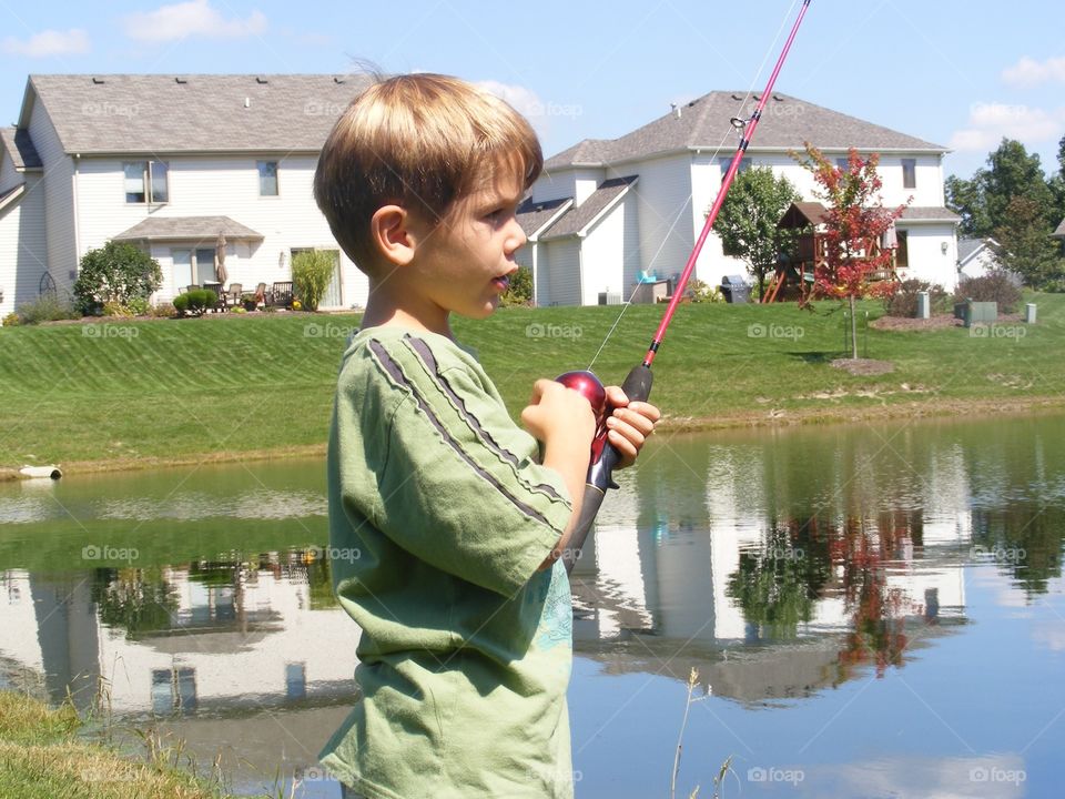 Boy holding fishing rob