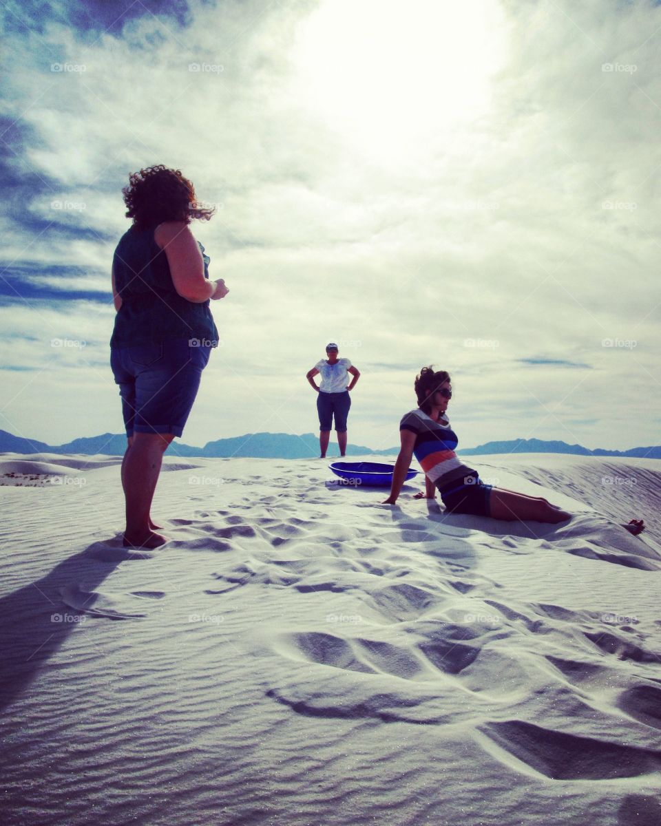 Hanging out and sand sledding on top of a sand dune at White Sands National Monument in New Mexico. During the summer of 2014 in 104 degrees Farenheit weather.
