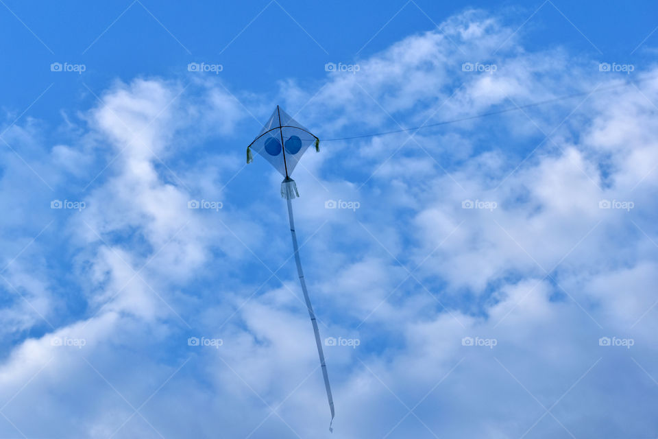 My kite is flying through the bright sky.