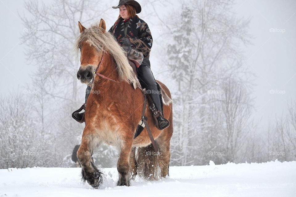 Girl riding her horse