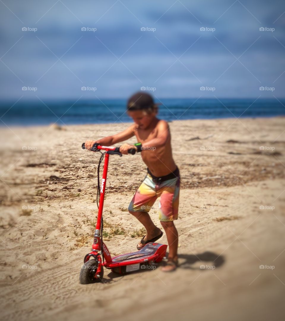 Lifestyle Photography Young Boy at the Beach on a Scooter, California 