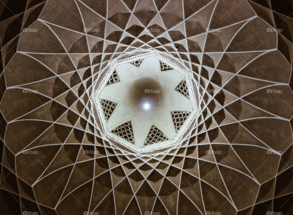 The magnificent architecture of a historical place in Yazd,Iran. Combination of light, shadow and art.