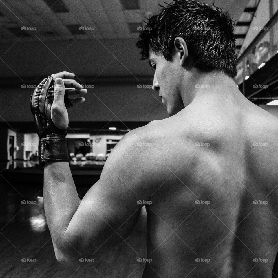 workout man with MMA fighting gloves in gym