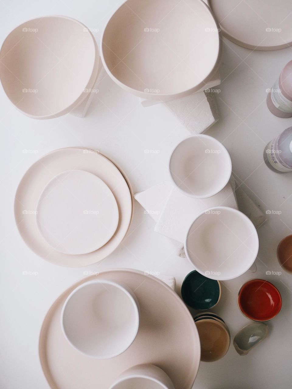 Round ceramic plates on a white table, top view, no people 