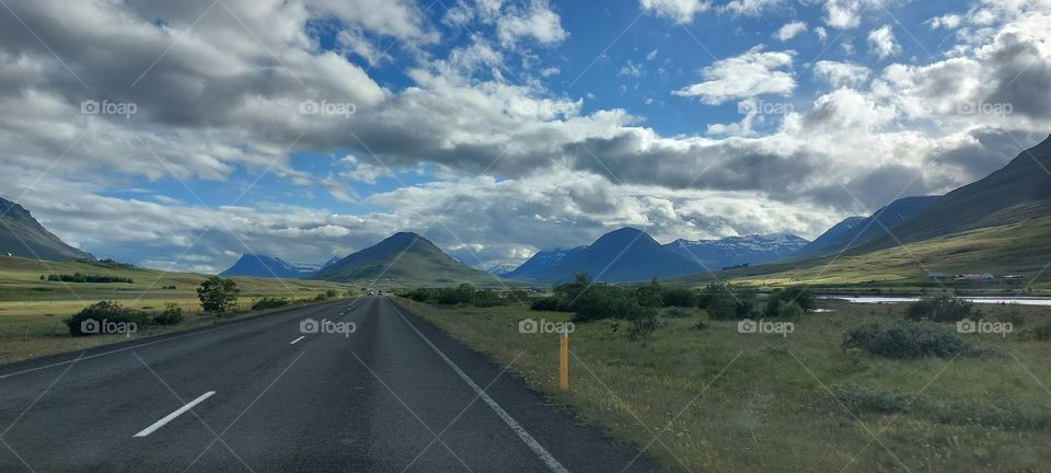 Exploring the nature. Winding road leading further into the mountains.