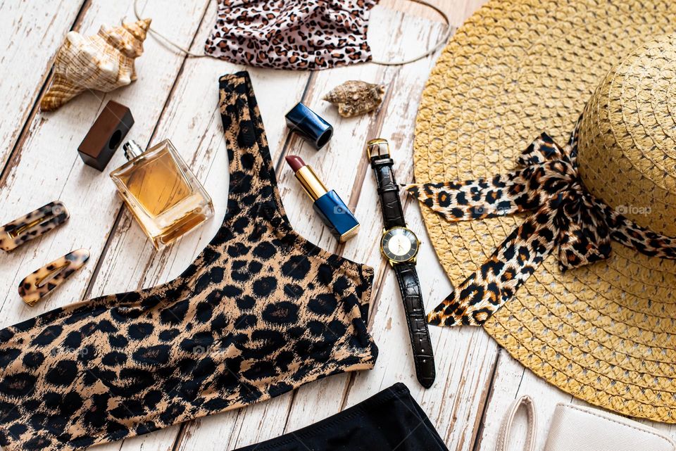 Accessories leopard print swimsuit, hat and parfumerie 