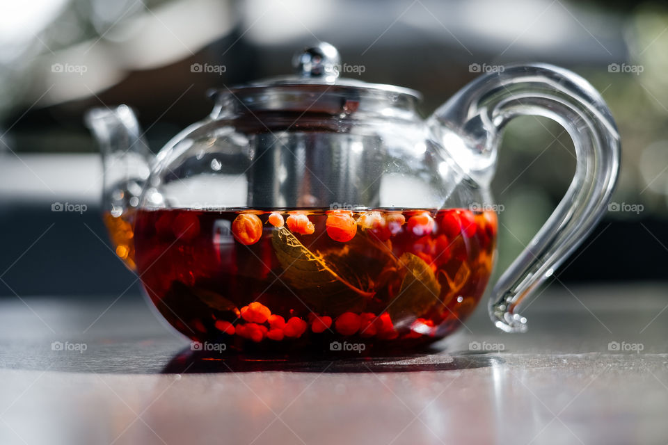 close up view of teapot filled with berry tea