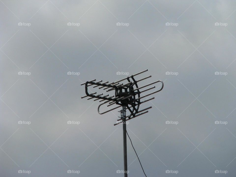 Close-up of antenna with a cloudy sky in low angle view