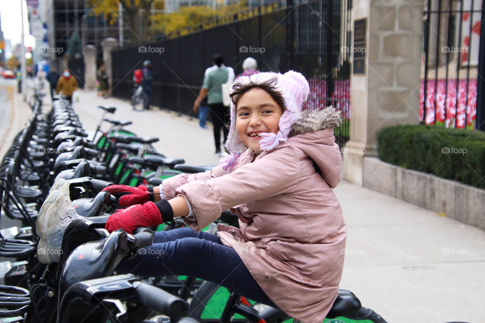 Cute girl on a city bike