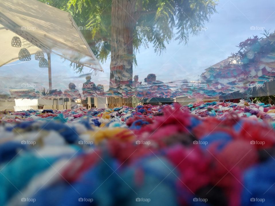 Reflection between a weaved mattress and a glassy table surface in Ibiza. How colorful!