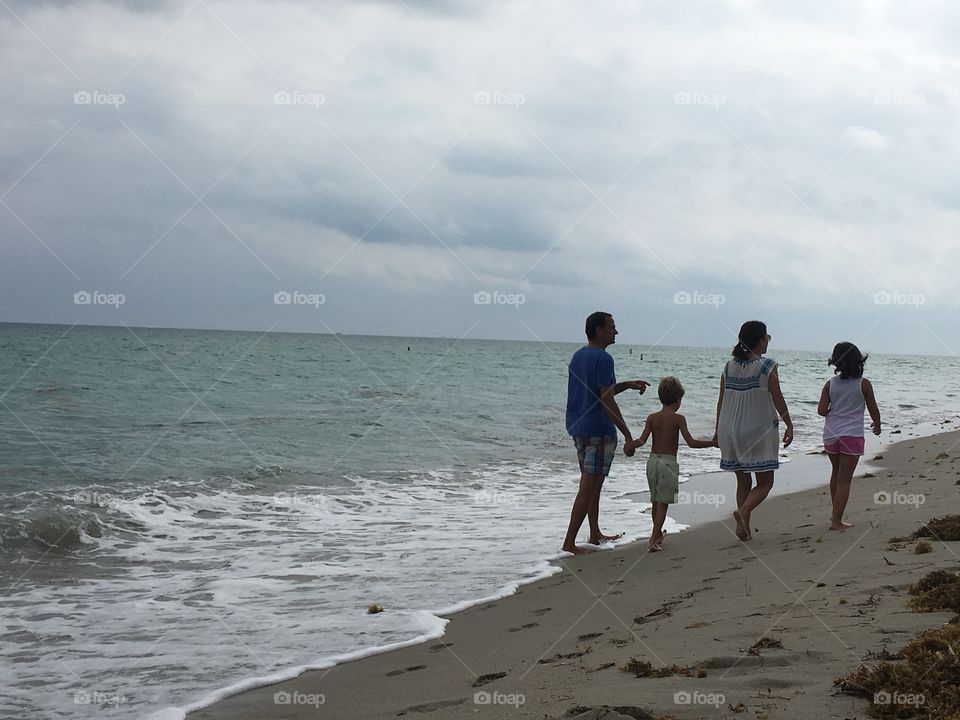 Family in beach walking 