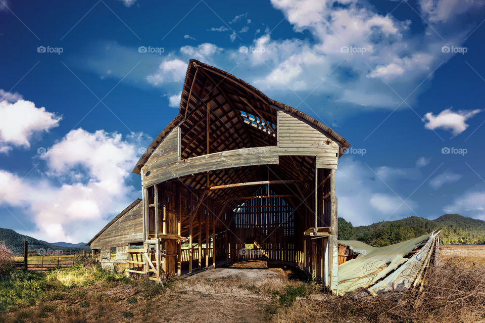 Abandoned wooden house at farm near mountain