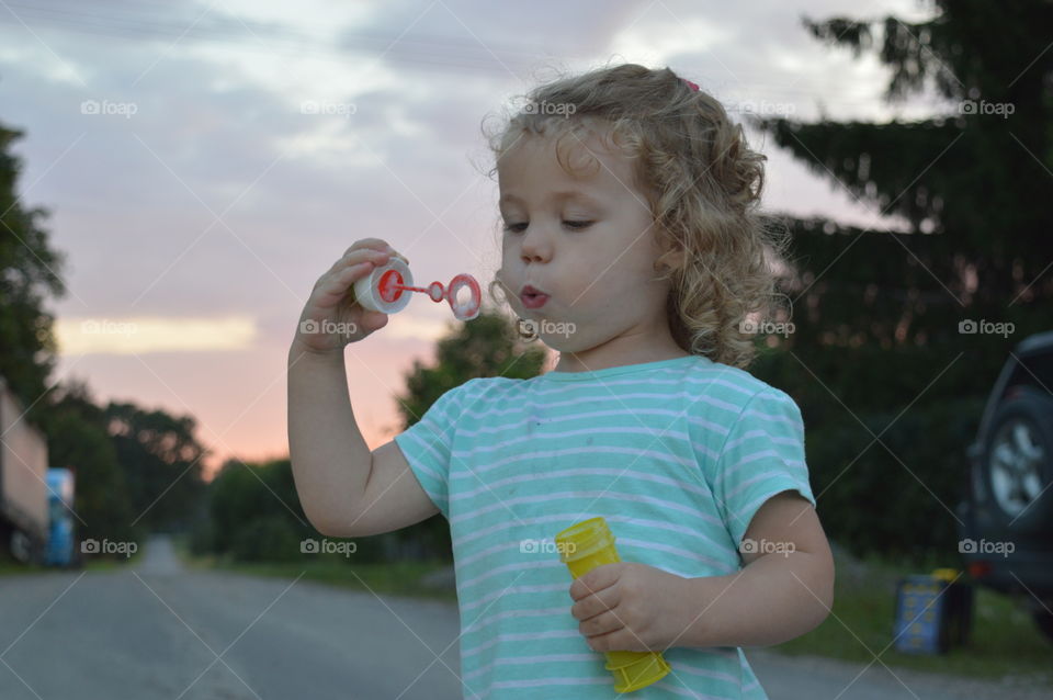 Girl trying make a bubbles