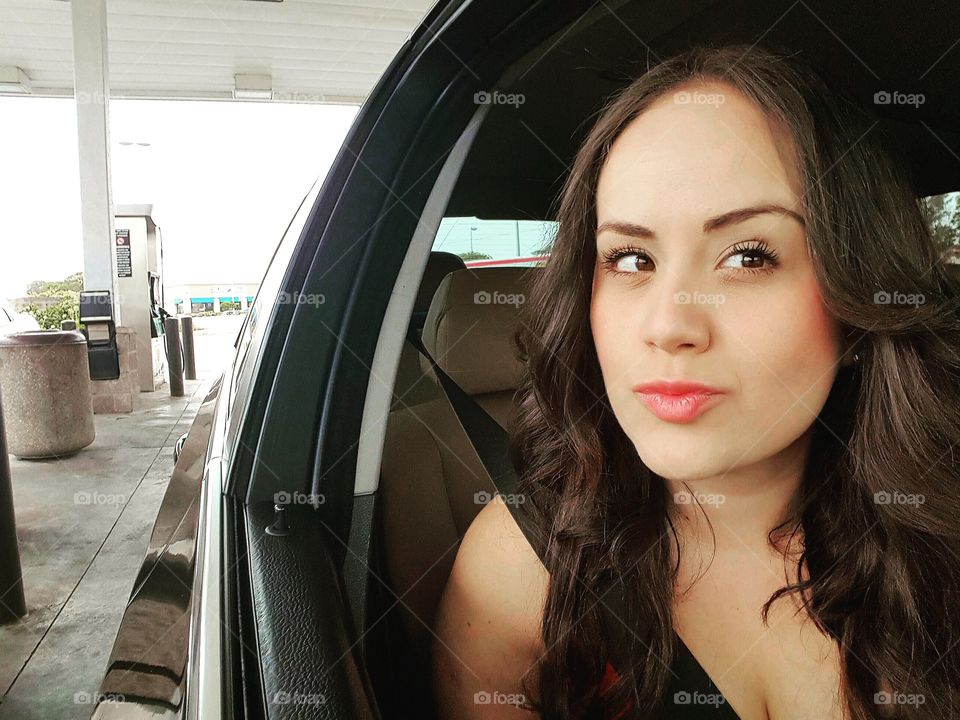 Woman in car at petrol station